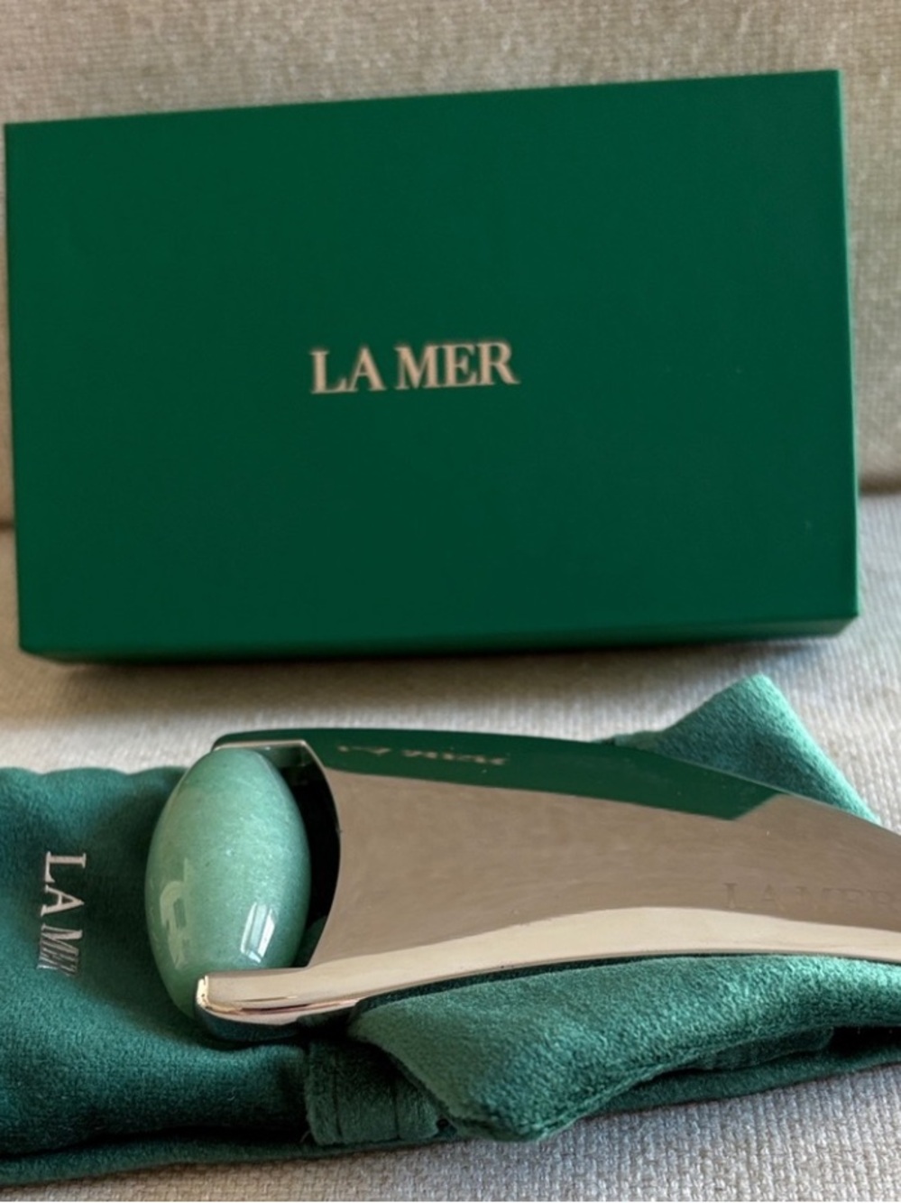 La Mer Silver Gua Sha Tool with White Jade Roller and Green Pouch